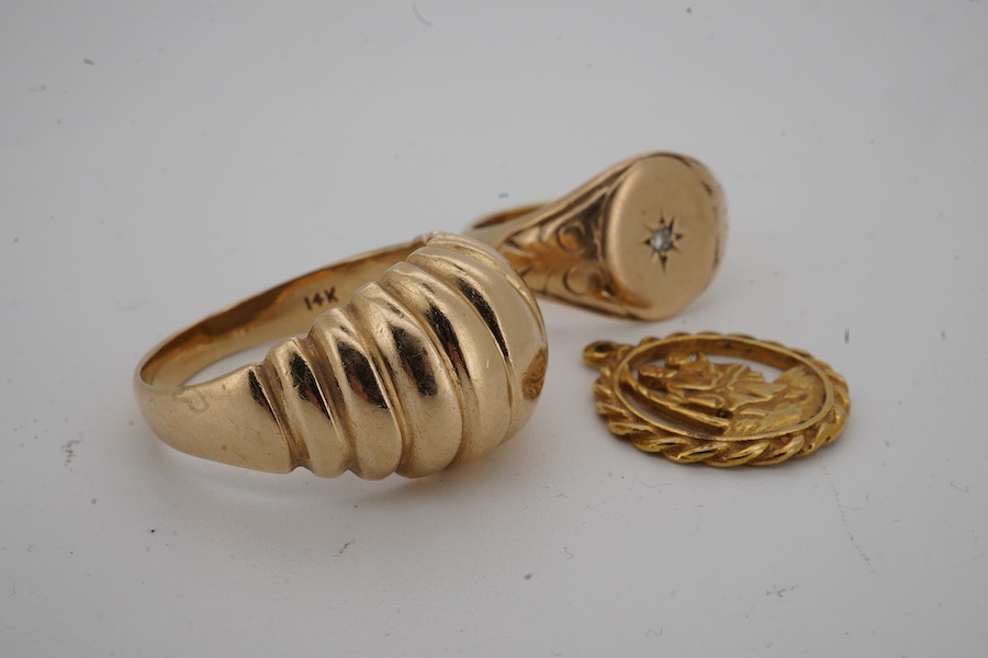 A 9ct gold and diamond set signet ring, size M/N, a fluted 9ct gold ring and a 9ct gold St. Christopher's charm, gross weight 13.2 grams.